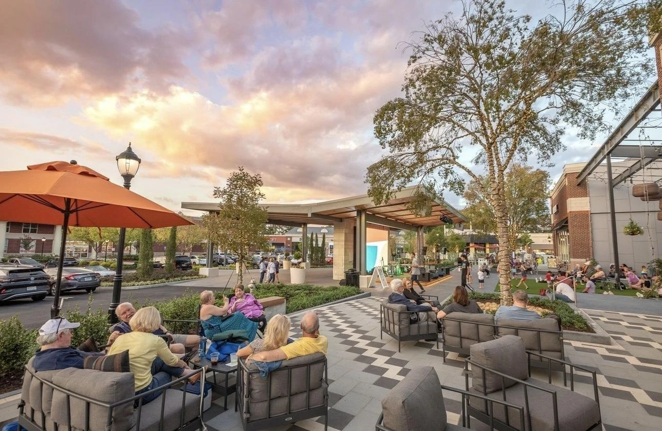 Outdoor seating and landscaped shopping plaza at sunset in East Cobb, unincorporated Cobb County, Georgia
